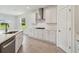 Modern kitchen with white cabinets, island, and stainless steel appliances at 5307 Cappleman Loop, Brooksville, FL 34601