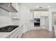 Clean kitchen featuring white cabinets, stainless steel appliances and a built-in oven at 5307 Cappleman Loop, Brooksville, FL 34601