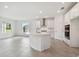 Modern kitchen with white cabinets and a curved island at 5307 Cappleman Loop, Brooksville, FL 34601