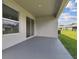 Covered patio with sliding glass door access and grassy backyard view at 5307 Cappleman Loop, Brooksville, FL 34601