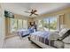 Bedroom with two beds, a ceiling fan, and natural light from multiple windows, creating a relaxing space at 123 Tidy Island Blvd, Bradenton, FL 34210