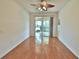 Bright bedroom with hardwood floors and sliding glass doors leading to a patio at 4264 Central Sarasota Pkwy # 116, Sarasota, FL 34238