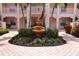 Community courtyard with fountain and tropical plants at 4264 Central Sarasota Pkwy # 116, Sarasota, FL 34238