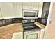 Stainless steel appliances including microwave and stovetop at 4264 Central Sarasota Pkwy # 116, Sarasota, FL 34238