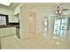 Open living area with tile floors and kitchen view at 4264 Central Sarasota Pkwy # 116, Sarasota, FL 34238