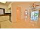 Open living area with tile floors and kitchen view at 4264 Central Sarasota Pkwy # 116, Sarasota, FL 34238