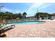 Community pool with lounge chairs and brick patio at 4264 Central Sarasota Pkwy # 116, Sarasota, FL 34238