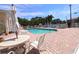 Community pool area with patio furniture and umbrella at 4264 Central Sarasota Pkwy # 116, Sarasota, FL 34238