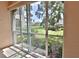 Screened sunroom with view of the community green space at 4264 Central Sarasota Pkwy # 116, Sarasota, FL 34238