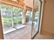 Bright sunroom with sliding glass doors offering a view of the lush green landscape at 4264 Central Sarasota Pkwy # 116, Sarasota, FL 34238