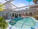 Inviting kidney-shaped pool with covered patio, lush landscaping, and pink flamingos at 7348 Phillips St, Sarasota, FL 34243