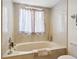 Bathroom with an oval bathtub, shower, and plenty of light at 5228 Landings Blvd # 202, Sarasota, FL 34231