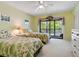 Guest bedroom with two twin beds and balcony access at 5228 Landings Blvd # 202, Sarasota, FL 34231