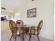 Small dining area with wicker chairs and glass table at 5228 Landings Blvd # 202, Sarasota, FL 34231