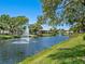 Serene lakefront property with water features and mature trees at 5228 Landings Blvd # 202, Sarasota, FL 34231