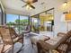 Spacious sunroom boasts wicker furniture and serene views at 5228 Landings Blvd # 202, Sarasota, FL 34231