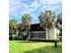 Two-story condo building with lush landscaping and a manicured lawn at 3500 El Conquistador Pkwy # 142, Bradenton, FL 34210