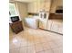 Kitchen with white cabinets, tile floors, and appliances at 3500 El Conquistador Pkwy # 142, Bradenton, FL 34210