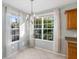 Bright dining area featuring tile floors, natural light, and an elegant chandelier at 5654 Simonton St, Bradenton, FL 34203
