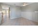 Open dining space with tiled floors, wainscoting, and a bright view into the kitchen and backyard at 5654 Simonton St, Bradenton, FL 34203
