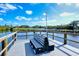 Picturesque view of a dock with a bench overlooking a serene lake and blue sky with some clouds at 5654 Simonton St, Bradenton, FL 34203