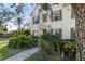 Charming two-story home featuring manicured landscaping, a welcoming walkway, and shuttered windows at 5654 Simonton St, Bradenton, FL 34203