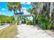 Charming white gazebo surrounded by lush greenery and sandy path, perfect for relaxation at 5654 Simonton St, Bradenton, FL 34203