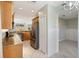 Open kitchen showcases stainless steel refrigerator, granite counters, and overlooks dining area at 5654 Simonton St, Bradenton, FL 34203