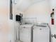 Laundry room with modern appliances and shelving for storage at 5654 Simonton St, Bradenton, FL 34203