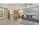 Inviting living room featuring tile floors, a comfortable couch, and seamless flow into the kitchen at 5654 Simonton St, Bradenton, FL 34203