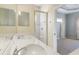 Well-appointed main bathroom features dual sinks, granite counters, and glass enclosed shower at 5654 Simonton St, Bradenton, FL 34203