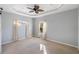 Spacious main bedroom featuring neutral carpet, tray ceiling and abundant natural light at 5654 Simonton St, Bradenton, FL 34203
