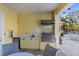 Outdoor kitchen with a built-in grill and sink, ideal for entertaining by the pool at 5654 Simonton St, Bradenton, FL 34203