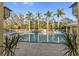 Resort-style pool with palm trees, lounge chairs, and serene views, perfect for relaxation at 5654 Simonton St, Bradenton, FL 34203