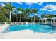 Community pool with ample lounge chairs and palm trees at 5654 Simonton St, Bradenton, FL 34203