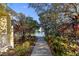 Scenic walking path leading to a tranquil lake with a fountain, surrounded by vibrant greenery at 5654 Simonton St, Bradenton, FL 34203
