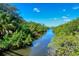 Scenic water view featuring a tranquil river lined with lush green trees and a clear blue sky at 5654 Simonton St, Bradenton, FL 34203