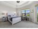 Spacious bedroom with a comfortable bed, large window, and workspace at 531 Ranger Ln, Longboat Key, FL 34228