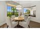 Breakfast nook boasts a round table and chairs, offering ample natural light and water views at 531 Ranger Ln, Longboat Key, FL 34228