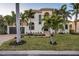 Luxury two-story home with tile roof and palm trees at 531 Ranger Ln, Longboat Key, FL 34228