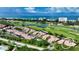 Aerial view of community near the ocean, golf course, and pool at 2383 Harbour Oaks Dr, Longboat Key, FL 34228