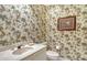 Small bathroom with unique monkey wallpaper and updated vanity at 2383 Harbour Oaks Dr, Longboat Key, FL 34228