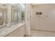 Double vanity bathroom with updated fixtures and large mirror at 2383 Harbour Oaks Dr, Longboat Key, FL 34228