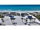 Beach with cabanas and palm trees at 2383 Harbour Oaks Dr, Longboat Key, FL 34228