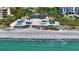 Aerial view of beach with cabanas and ocean at 2383 Harbour Oaks Dr, Longboat Key, FL 34228