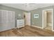 Bedroom with wood floors, built-in shelving, and access to a bathroom at 2383 Harbour Oaks Dr, Longboat Key, FL 34228