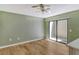 Bright bedroom with wood floors and sliding glass doors leading to a patio at 2383 Harbour Oaks Dr, Longboat Key, FL 34228