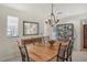 Dining room with a light wood table, six chairs, and a built-in shelving unit at 2383 Harbour Oaks Dr, Longboat Key, FL 34228