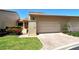 Front view of charming villa with attached garage and manicured lawn at 2383 Harbour Oaks Dr, Longboat Key, FL 34228