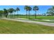 Expansive golf course view with palm trees and a clear blue sky at 2383 Harbour Oaks Dr, Longboat Key, FL 34228